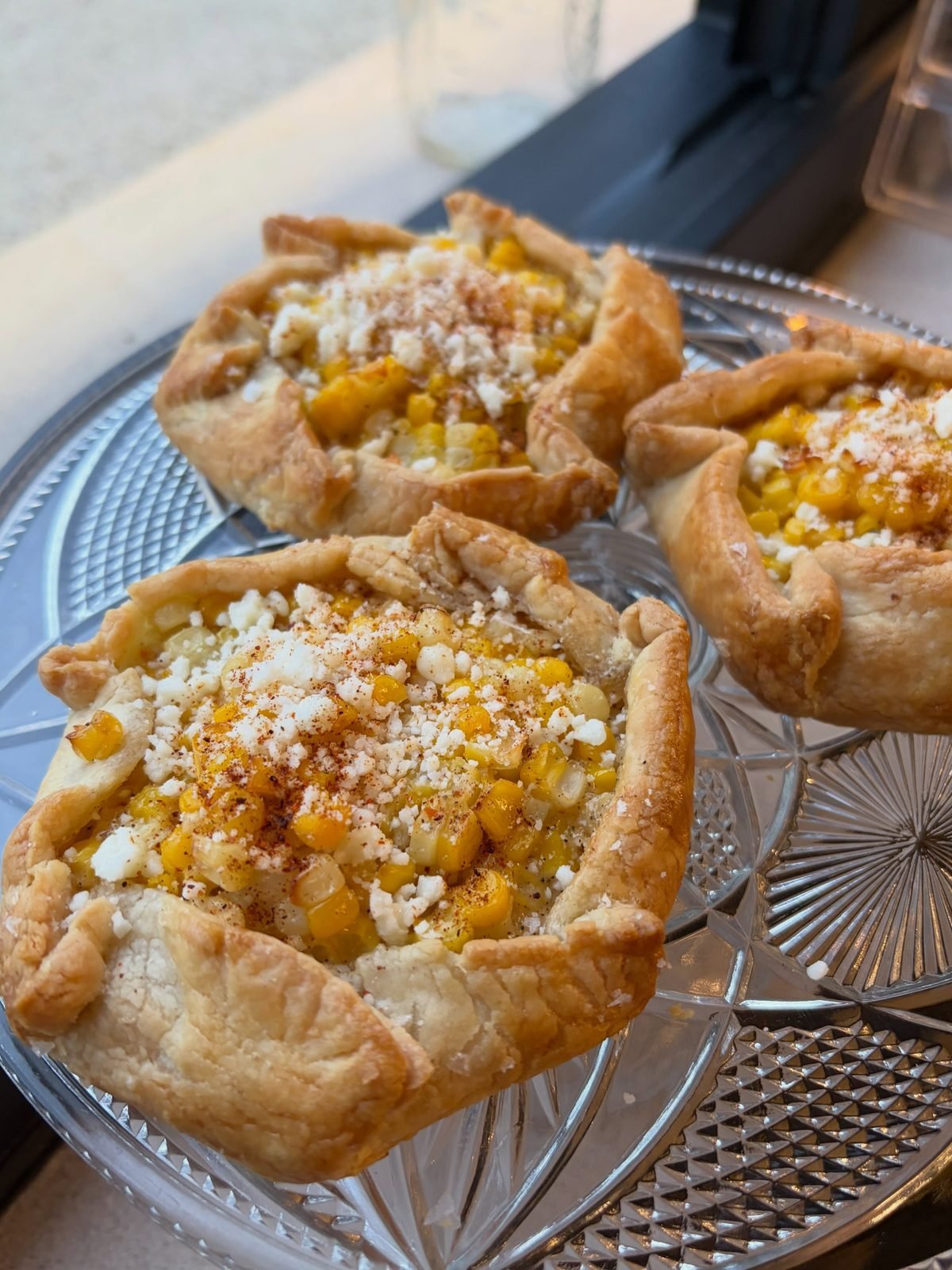 Elote galettes topped with corn and cotija