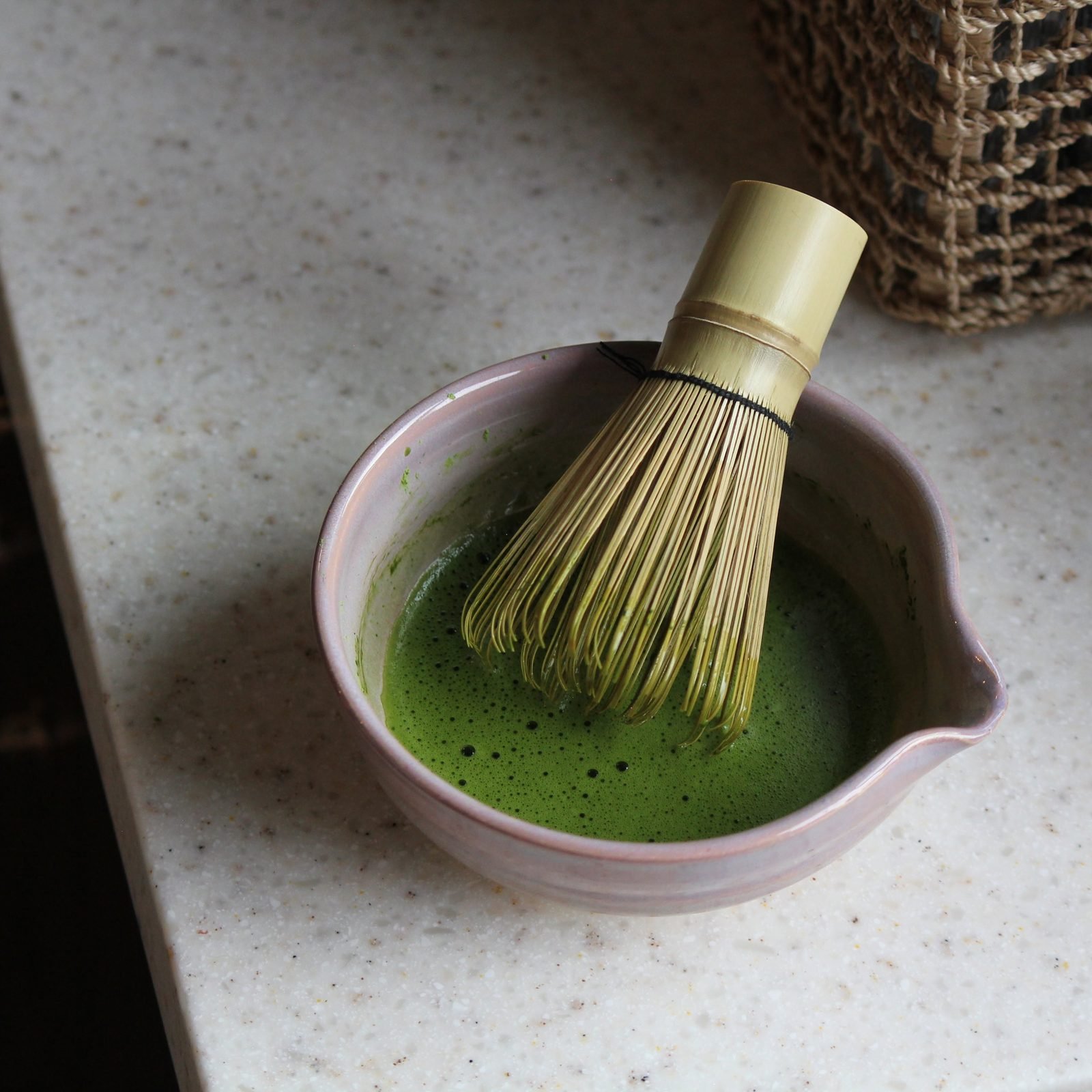 Matcha being whisked in a ceramic bowl